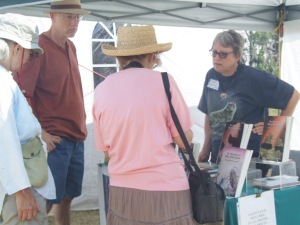 Deborah K. Frontiera chats with book browsers at the annual Eagle Harbor Art Show on the shores of Lake Superior.